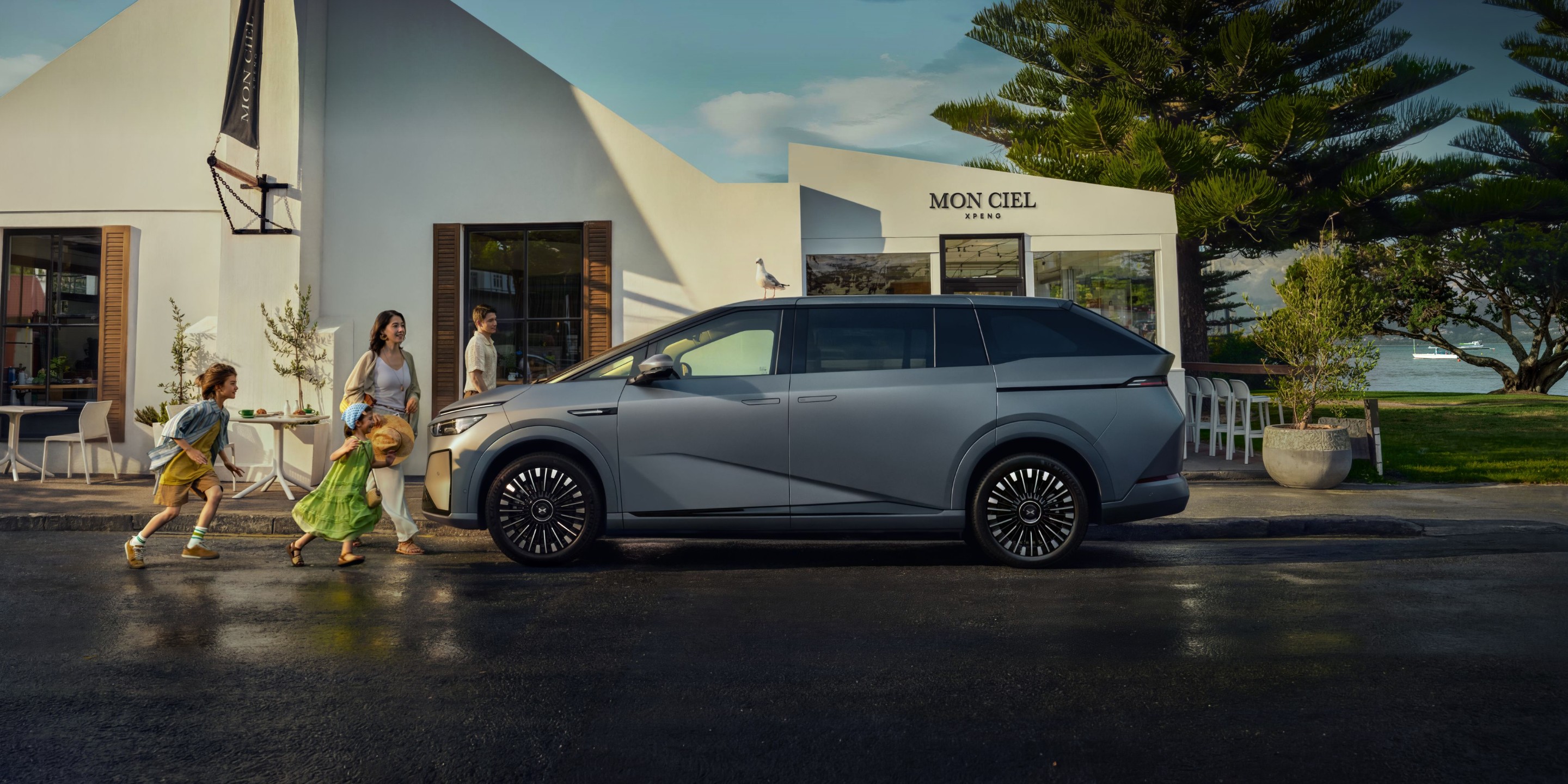 XPENG X9 parked outside a modern home