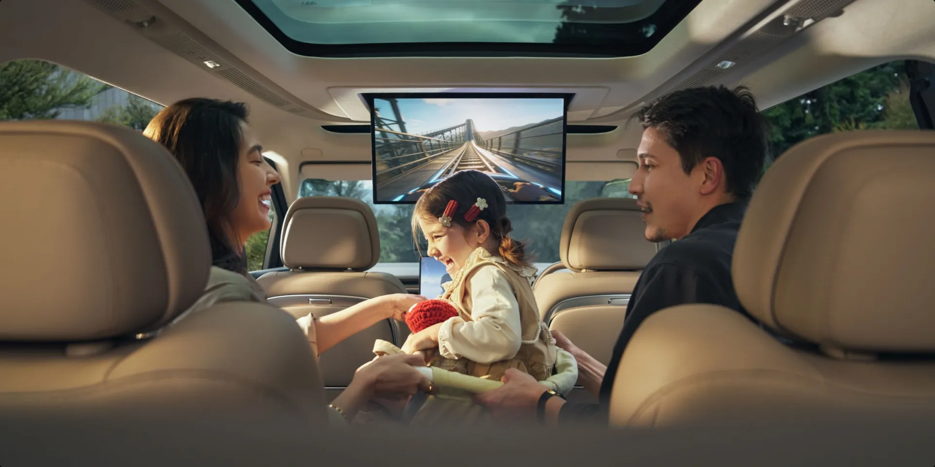 Family watching the rear entertainment screen inside the XPENG X9
